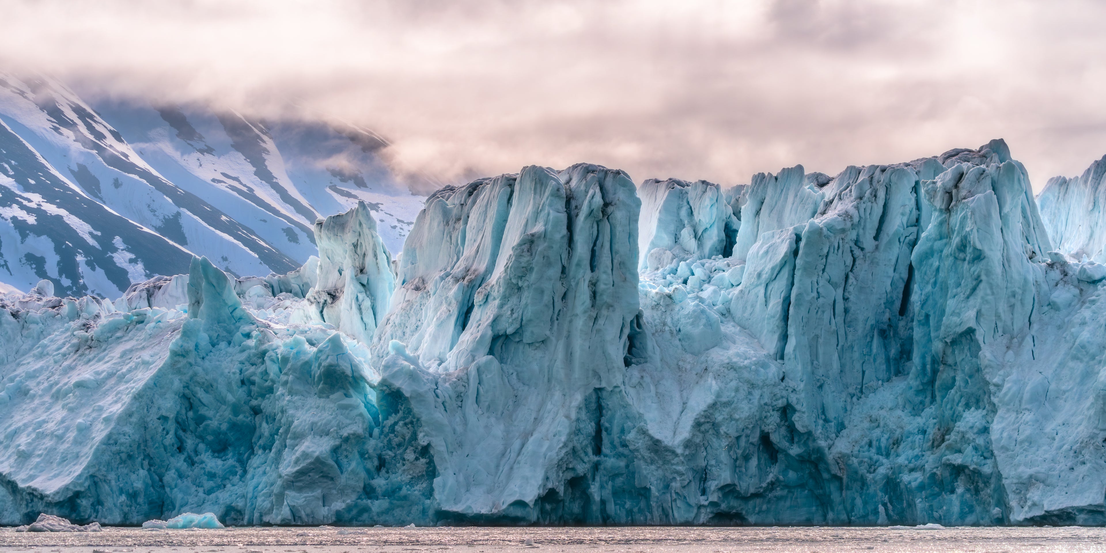 Panorama of a large glacier with a cloudy sky